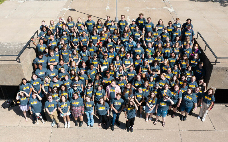 A larger group of LEAD members, smiling outside of Albertson Hall.