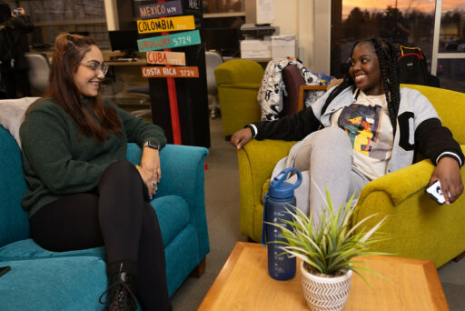 Two students smiling at each other in the Multicultural Resource Center.