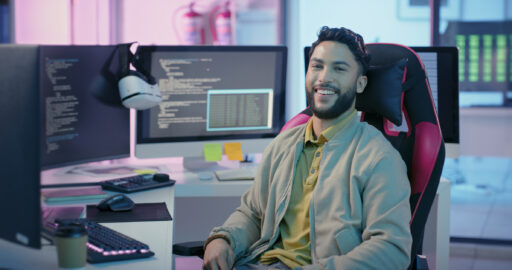 man at computer smiling