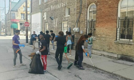 A school and neighborhood trash clean-up event organized by environmental interns at Reflo.