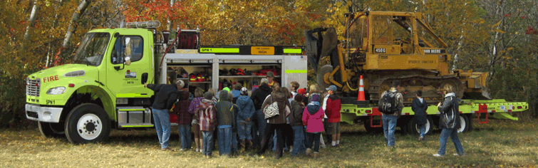 Wildland firefighter shows students his truck