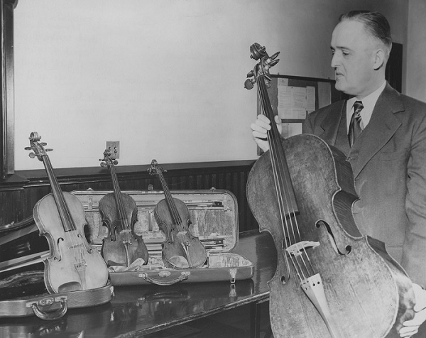 The late Edmund Bukolt is shown with valuable string instruments he collected. A private charitable organization he founded will fund a new endowed professorship in cello and music education advocacy at UWSP.