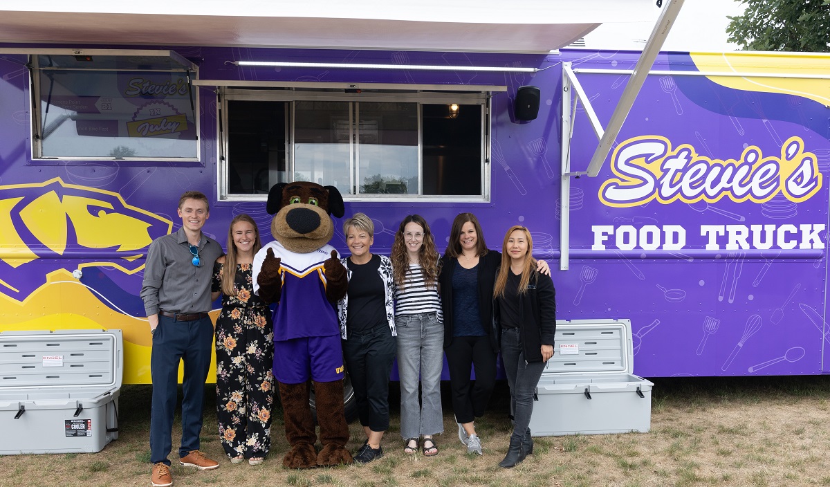 Olivia Molle, second from left, celebrates the opening of Stevie's with a group of MBA staff members.