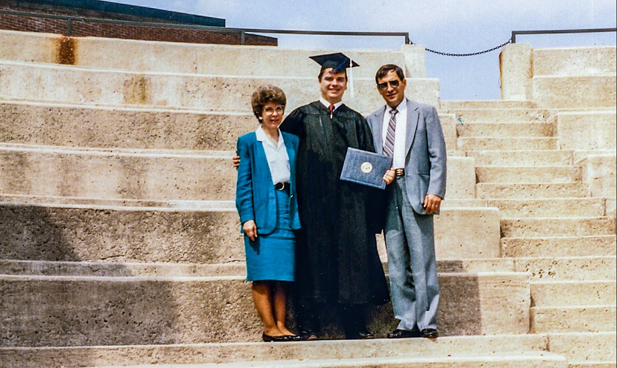Dean Brian Sloss, a first-generation student, at his undergraduate graduation with his supportive parents.