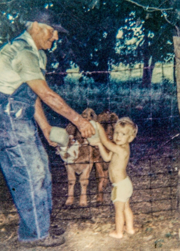 A young Brian Sloss shows an interest in animals at a young age, helping his grandpa feed the calves.