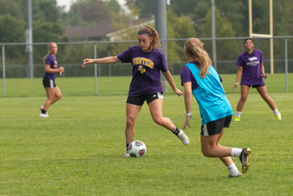 soccer player kicking ball