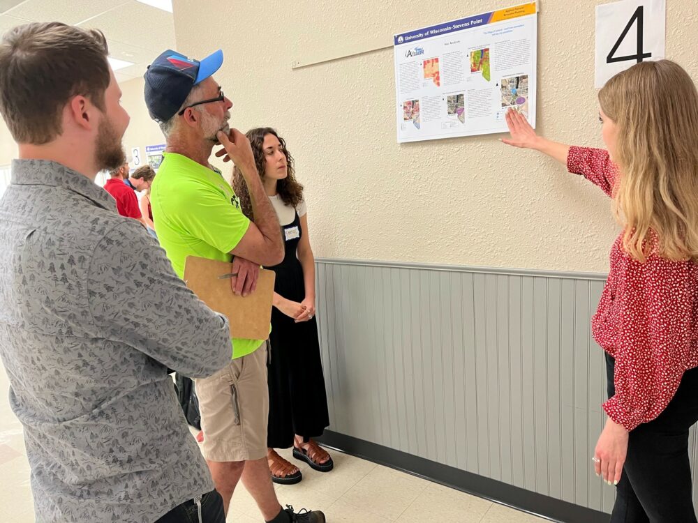 Student shares concepts with community members at the open house
