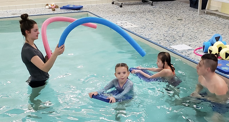 Emily Wintrone, left, took the adapted physical education course last spring and now volunteers on Fridays.