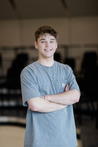 Student standing and smiling