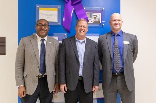 Chancellor Thomas Gibson, Dean Brian Sloss and Ray Ackerlund, Skyward President standing next to each other smiling