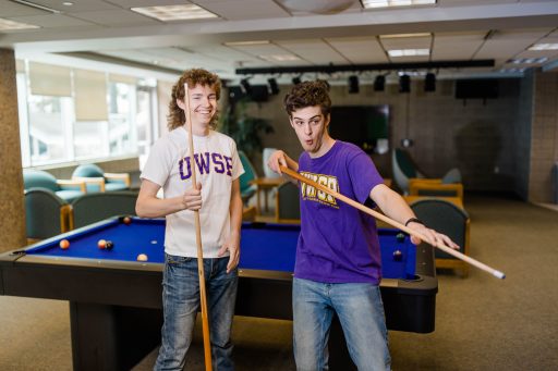 Two students playing pool