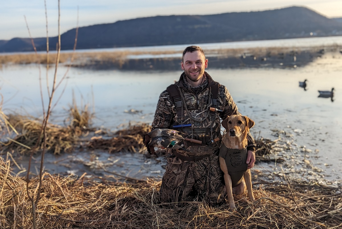 Cody Kamrowski, '16, with his dog, Nova, works to preserve outdoor habitats.