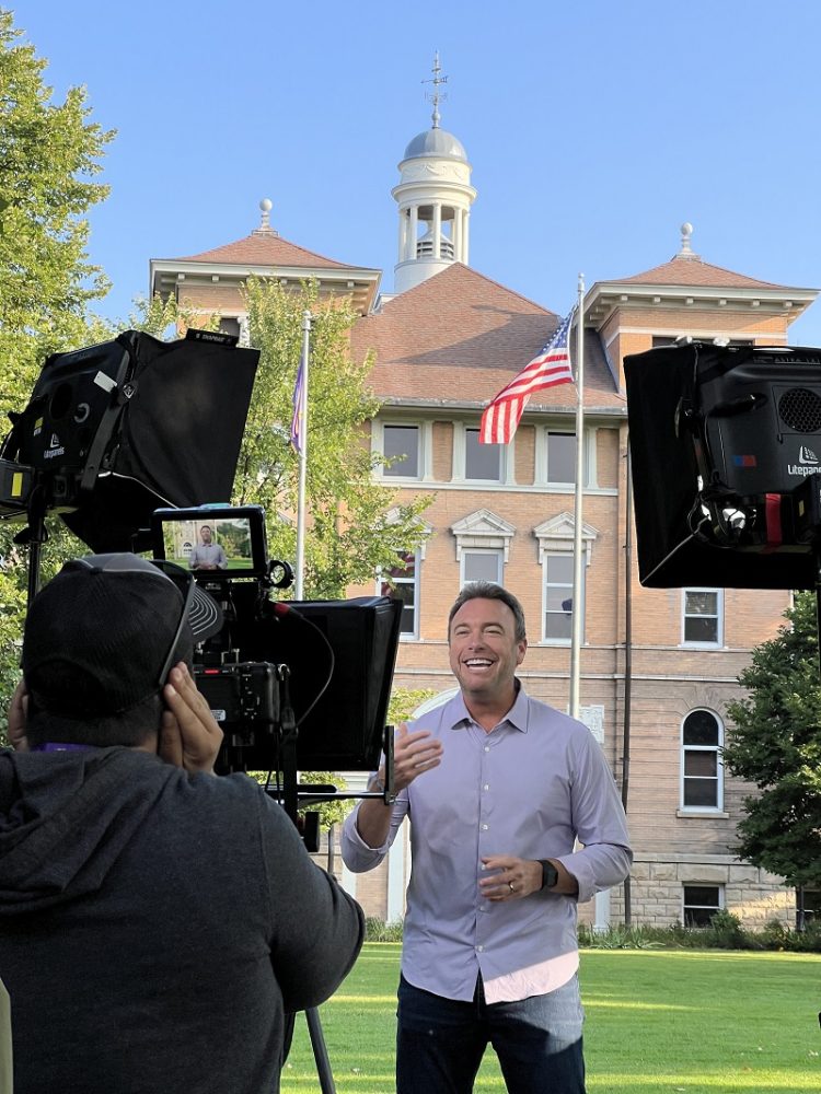 Host Alex Boylan films his introductions on the front lawn of Old Main.