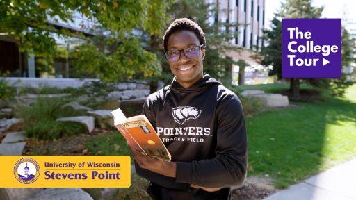 Student posing with a book