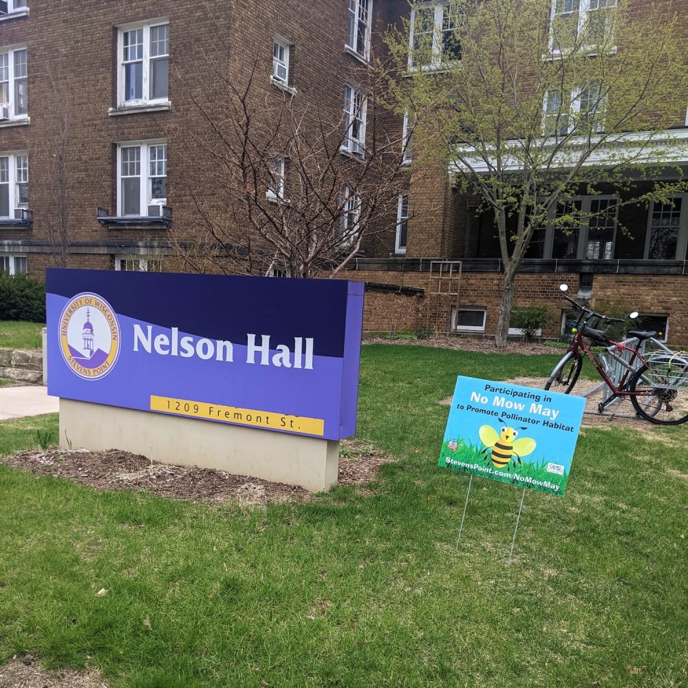 No mow May sign in front of Nelson hall building