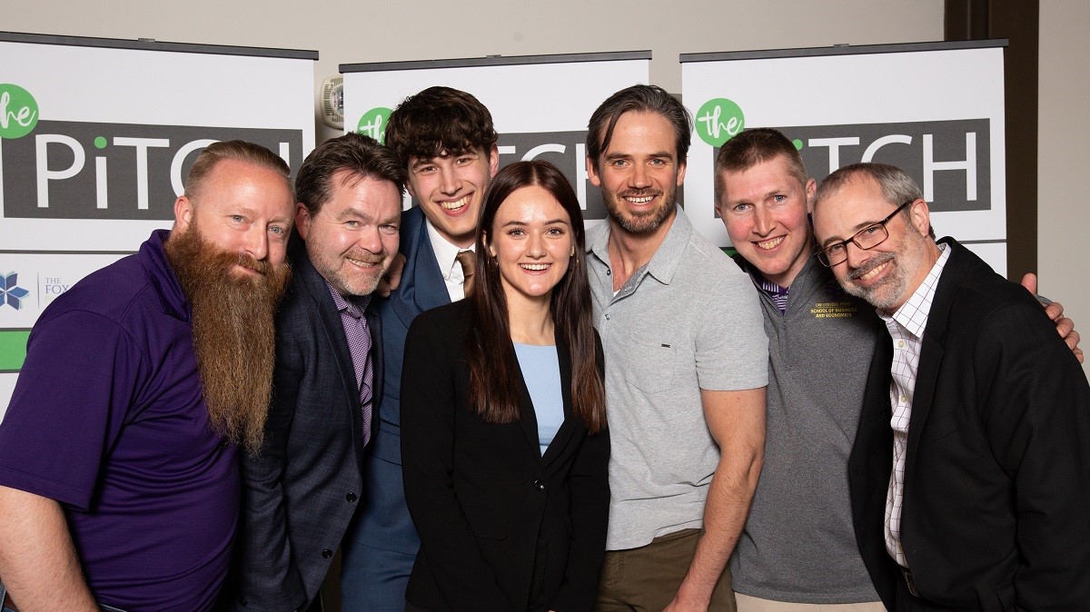 Pictured at The Pitch competition are Patrick Gatterman, SBDC director; Timothy McKeough, business consultant and coach; Alex Suscha, business administration student and fellow competitor; Densow; Jackson Burgau, SBDC business consultant; Reed Stratton, associate professor of business; and Kevin Neuman, head of Sentry School of Business and Economics.