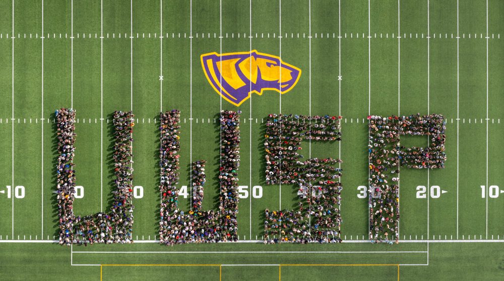 UWSP aerial drone class photo with students arranged in the letters of UWSP