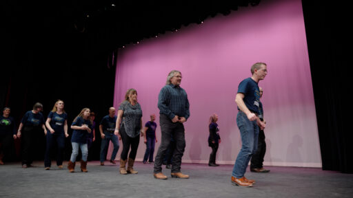 A group performing on stage at the Marshfield Area Cultural Fair