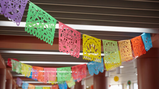 A string of colorful banners hanging from the ceiling at the Marshfield Area Cultural Fair