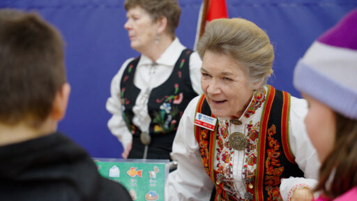 A performer talking to an attendee at the Marshfield Area Cultural Fair