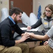 UWSP DPT students Caden Prahl and Amy Griffin work with a patient at the UWSP Physical Therapy Clinic housed at the Stevens Point Area YMCA as part of their integrated clinical practice course.