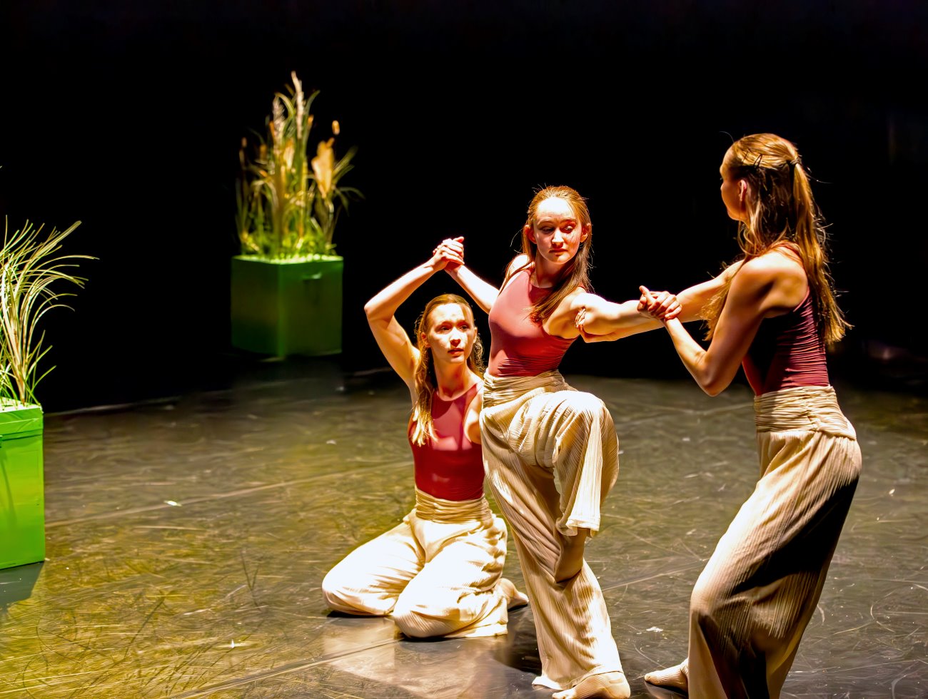 3 students dancing on stage