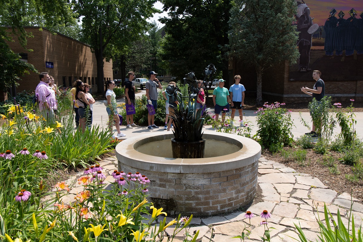 Students and families touring UWSP in front of the Iris Fountain.