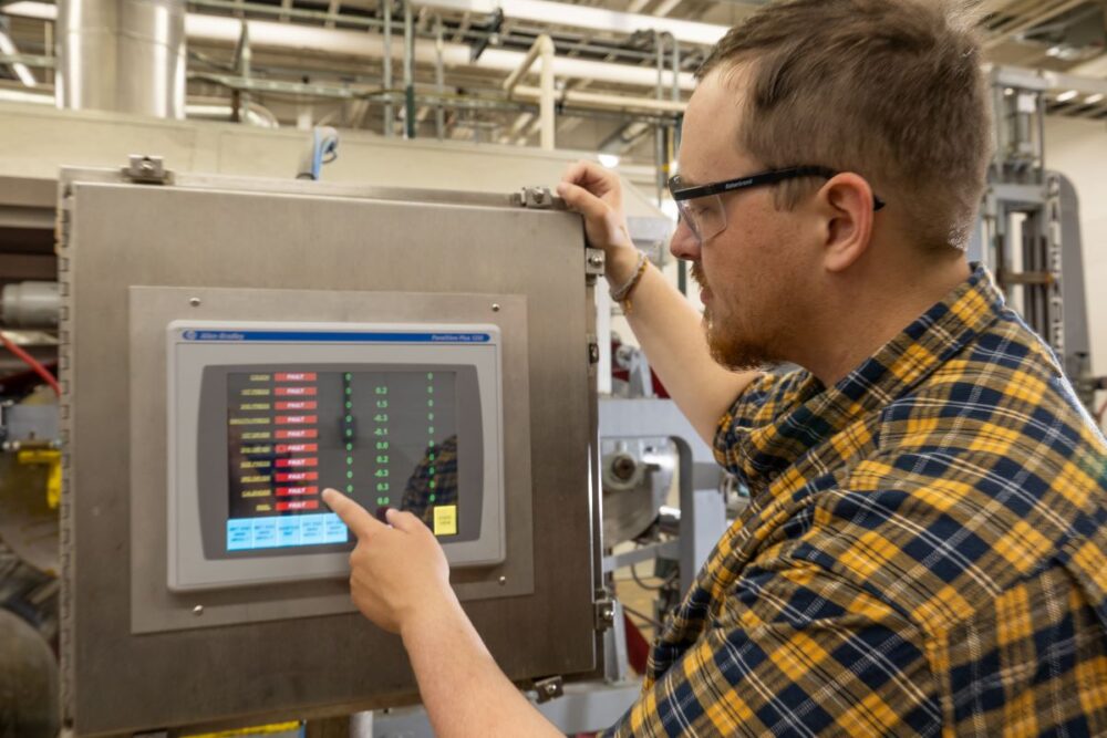 Touchscreen digital control panel displaying real-time diagnostics and controls for a paper machine.