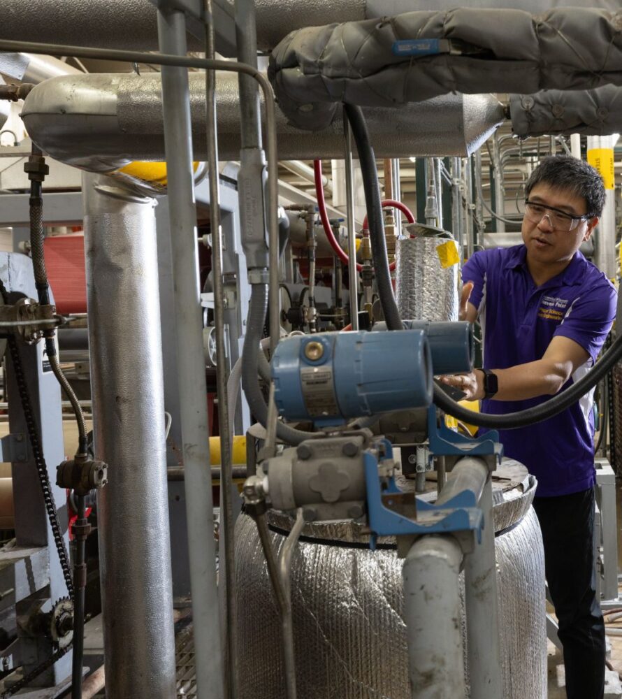 A faculty member shows how to examine insulated pipes and reading pressure gauges on a steam distribution line.